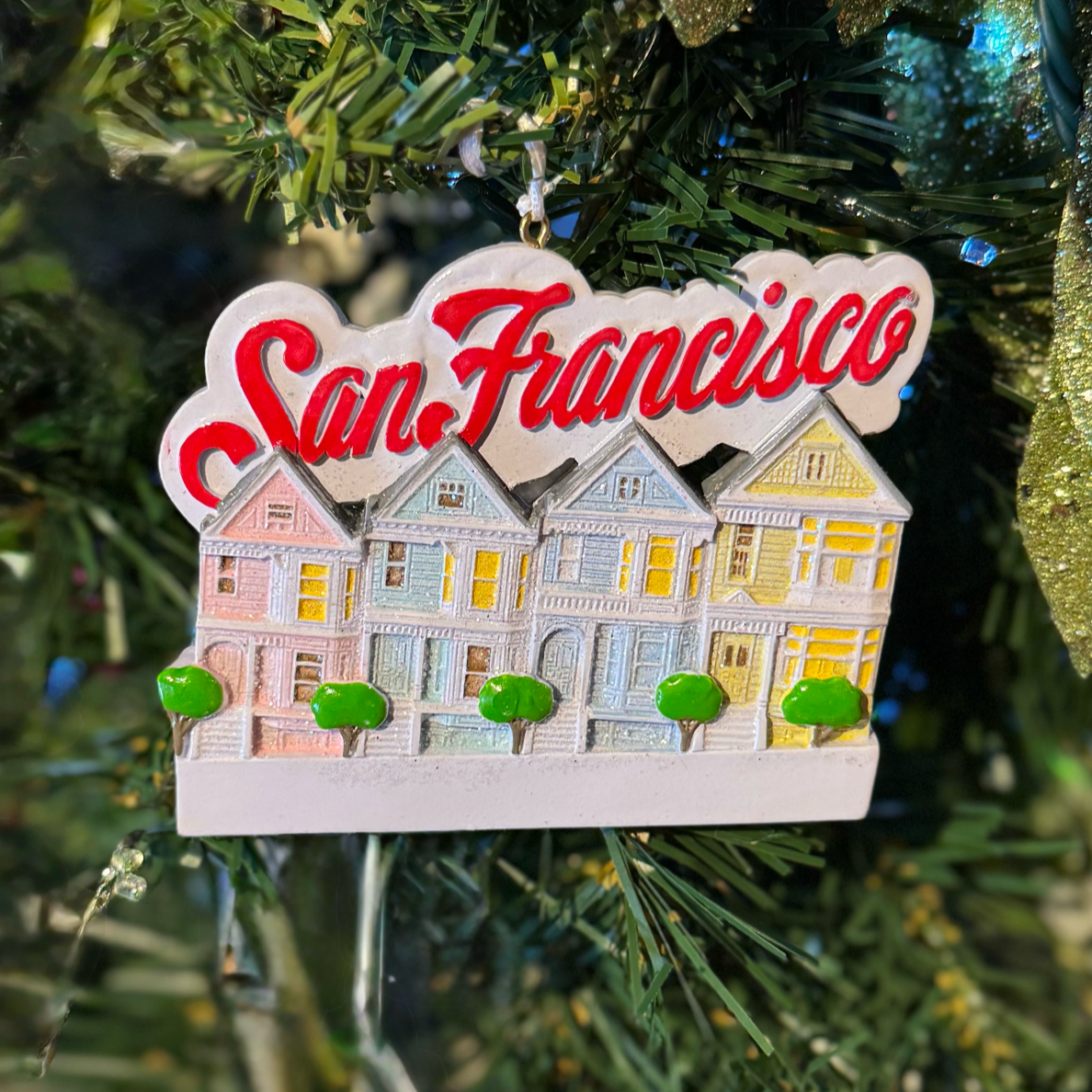 Decorative ornament with 'San Francisco' text and house design on a Christmas tree.